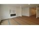 Open living room with a modern fireplace and access to other rooms at 5032 Carmine St, Brownsburg, IN 46112
