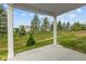 Covered patio overlooking manicured lawn and trees at 5032 Carmine St, Brownsburg, IN 46112