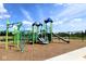 A playground featuring colorful equipment, slides and swings set against a bright blue sky at 5032 Carmine St, Brownsburg, IN 46112