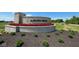 Stone sign for Auburn Ridge community with red flowers and landscaping in front at 5032 Carmine St, Brownsburg, IN 46112