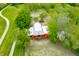 A picturesque aerial view of a property with a barn, surrounded by trees and a gravel driveway at 5335 W 550 S, Trafalgar, IN 46181