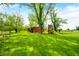 Expansive backyard featuring a shed and a playground, offering a blend of utility and recreation at 5335 W 550 S, Trafalgar, IN 46181