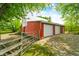 Versatile barn with garage doors offering ample storage and workspace, set on a gravel lot at 5335 W 550 S, Trafalgar, IN 46181