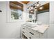 Bright bathroom featuring a vanity with marble countertops and a window with woven blinds at 5335 W 550 S, Trafalgar, IN 46181
