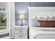 Bedroom features hardwood floors, modern furniture, a gray accent wall, and bright, natural light at 5335 W 550 S, Trafalgar, IN 46181