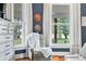 Bedroom features hardwood floors, modern furniture, a gray accent wall, and bright, natural light at 5335 W 550 S, Trafalgar, IN 46181