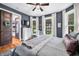 Bedroom features hardwood floors, modern furniture, a gray accent wall, and bright, natural light at 5335 W 550 S, Trafalgar, IN 46181