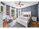 Bedroom features hardwood floors, modern furniture, a gray accent wall, and bright, natural light at 5335 W 550 S, Trafalgar, IN 46181