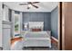Bedroom features hardwood floors, modern furniture, a gray accent wall, and bright, natural light at 5335 W 550 S, Trafalgar, IN 46181