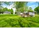 A view of a chicken coop in a yard with farm house in the background of the home at 5335 W 550 S, Trafalgar, IN 46181