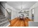 Inviting dining area with hardwood floors, a stone fireplace, and a view of the staircase at 5335 W 550 S, Trafalgar, IN 46181