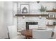 Dining room with whitewashed brick fireplace and hardwood floors at 5335 W 550 S, Trafalgar, IN 46181