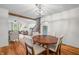 Elegant dining room with hardwood floors, a wooden table, and stylish chairs at 5335 W 550 S, Trafalgar, IN 46181