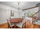 Charming dining room featuring hardwood floors, a wooden table, and seamless access to other rooms at 5335 W 550 S, Trafalgar, IN 46181
