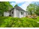 Exterior view of the house featuring a well-maintained lawn and wooden deck at 5335 W 550 S, Trafalgar, IN 46181
