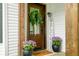 Charming front door with a wreath, potted flowers, and a welcome sign at 5335 W 550 S, Trafalgar, IN 46181