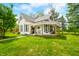 Charming two-story farmhouse with a covered porch and well-maintained lawn at 5335 W 550 S, Trafalgar, IN 46181