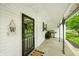 Inviting front porch featuring a black metal door and a charming 'W' decor at 5335 W 550 S, Trafalgar, IN 46181