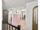 Upstairs hallway with views to a bathroom, a bedroom, and a gold framed mirror at 5335 W 550 S, Trafalgar, IN 46181