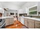 Bright kitchen with white cabinets, stainless steel appliances, and hardwood floors throughout at 5335 W 550 S, Trafalgar, IN 46181