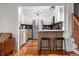 Open kitchen with barstool seating, stainless steel appliances, and access to the living room at 5335 W 550 S, Trafalgar, IN 46181