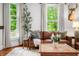 Bright living room with hardwood floors, natural light, and a comfortable leather sofa at 5335 W 550 S, Trafalgar, IN 46181