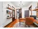 Bright office features hardwood floors, floating shelves, modern light fixture, and a view of the bedroom at 5335 W 550 S, Trafalgar, IN 46181