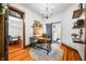 Bright office with a sliding door to a bathroom, wood floors, a desk, and a stylish light fixture at 5335 W 550 S, Trafalgar, IN 46181