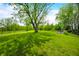 Lush, green yard with mature trees offering ample shade and a serene, inviting outdoor space at 5335 W 550 S, Trafalgar, IN 46181