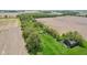 Aerial view showing land with trees, grassland, and remnants of old buildings bordering farmland at 5758 N 1200 E, Sheridan, IN 46069