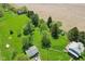 Aerial view of property showing vast acreage, mature trees, multiple structures, and lush green lawn at 5758 N 1200 E, Sheridan, IN 46069