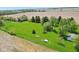 Lush lawn surrounds home and outbuildings. Expansive property with mature trees and agricultural fields at 5758 N 1200 E, Sheridan, IN 46069