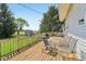 Outdoor living area with a spacious wooden deck, dining furniture, and a view of the surrounding landscape at 5758 N 1200 E, Sheridan, IN 46069