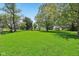 Expansive backyard features a lush lawn and mature trees, perfect for outdoor recreation and relaxation at 5758 N 1200 E, Sheridan, IN 46069