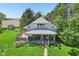 Two-story home with wraparound porch, large yard, mature trees, and ample outdoor living spaces at 5758 N 1200 E, Sheridan, IN 46069