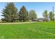Lush green front yard with mature trees leading to a home and garage at 5758 N 1200 E, Sheridan, IN 46069