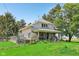 Charming two-story home featuring a covered front porch, steps to the front door, and mature trees on a lush green lawn at 5758 N 1200 E, Sheridan, IN 46069