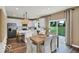 Bright kitchen featuring white cabinets, stainless steel appliances, an island, and an adjacent dining area at 5931 Sterling Dr, Whitestown, IN 46075