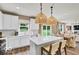 Bright, modern kitchen featuring white cabinets, quartz countertops, an island, and stainless steel appliances at 5931 Sterling Dr, Whitestown, IN 46075