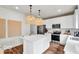 Modern kitchen with white cabinets, an island, stainless steel appliances, and stylish pendant lighting at 5931 Sterling Dr, Whitestown, IN 46075