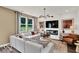 Comfortable living room with large windows, a fireplace, modern furniture, and neutral tones at 5931 Sterling Dr, Whitestown, IN 46075