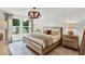 This main bedroom offers a calm atmosphere with a woven chandelier and bright natural light at 5931 Sterling Dr, Whitestown, IN 46075