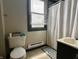 Cozy bathroom with neutral walls, a window, and essential fixtures at 600 S Oak St, Fortville, IN 46040