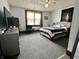 Comfortable bedroom featuring carpet floors, a bed, dresser, and window at 600 S Oak St, Fortville, IN 46040