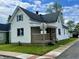 Quaint home featuring a covered front porch, well-maintained lawn, and classic architectural details at 600 S Oak St, Fortville, IN 46040