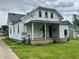 Charming exterior of a two-story home with a front porch and green lawn at 600 S Oak St, Fortville, IN 46040