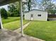 View of the garage from under the house porch with a green lawn at 600 S Oak St, Fortville, IN 46040