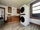Laundry room with stacked washer and dryer and wood cabinets at 600 S Oak St, Fortville, IN 46040