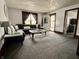Comfortable living room with plush seating, neutral carpet, and natural light streaming through the window at 600 S Oak St, Fortville, IN 46040
