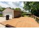 Large backyard deck adjacent to garage with outdoor grill, perfect for entertainment and relaxation at 6040 Manker St, Indianapolis, IN 46227